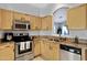 Bright kitchen featuring stainless steel appliances, granite countertops, and seamless flow to the other rooms at 1673 S 171St Dr, Goodyear, AZ 85338