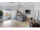 Bright living room with tile floors, slider to the pool, and a comfortable gray sofa at 1673 S 171St Dr, Goodyear, AZ 85338