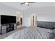 Spacious main bedroom featuring a ceiling fan, neutral-colored walls, and an ensuite bathroom for added convenience at 1673 S 171St Dr, Goodyear, AZ 85338