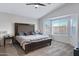 Main bedroom with a large bed, complemented by a bay window, and soft, neutral tones at 1673 S 171St Dr, Goodyear, AZ 85338