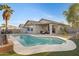 Inviting backyard features a sparkling pool, lush landscaping, and covered patio creating a private outdoor oasis at 1673 S 171St Dr, Goodyear, AZ 85338