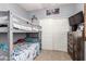 This bunk bedroom is complete with a dresser and a mounted television at 17937 W Westpark Blvd, Surprise, AZ 85388