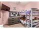 This pink bedroom features a bunk bed, a dresser, and decorative accents at 17937 W Westpark Blvd, Surprise, AZ 85388