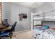 This bedroom features a bunk bed, a desk, and a decorative display shelf at 17937 W Westpark Blvd, Surprise, AZ 85388