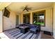 Relaxing covered patio with ceiling fan, comfortable seating and views of the landscaped yard at 17937 W Westpark Blvd, Surprise, AZ 85388