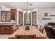 Inviting dining room features a wooden table, ample seating, and stylish shuttered windows at 17937 W Westpark Blvd, Surprise, AZ 85388