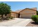 Charming single-story home with a well-manicured front yard, three-car garage and neutral color palette at 17937 W Westpark Blvd, Surprise, AZ 85388