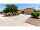 Inviting single-Gathering home boasts a large driveway, three-car garage, and tidy desert landscaping at 17937 W Westpark Blvd, Surprise, AZ 85388