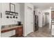 Functional hallway area with a pantry and stainless steel refrigerator at 17937 W Westpark Blvd, Surprise, AZ 85388