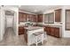Stylish kitchen with granite countertops, central island, stainless appliances, and ample cabinet space at 17937 W Westpark Blvd, Surprise, AZ 85388
