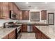 Beautiful kitchen features granite countertops, stainless steel appliances, and ample cabinet space at 17937 W Westpark Blvd, Surprise, AZ 85388