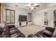 Bright living room with a media center and comfortable leather sofas at 17937 W Westpark Blvd, Surprise, AZ 85388
