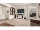 Open concept living room featuring built-in cabinets, a sleek entertainment center, and neutral carpet at 17937 W Westpark Blvd, Surprise, AZ 85388