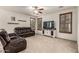 Comfortable living room with a large screen TV and cozy leather seating at 17937 W Westpark Blvd, Surprise, AZ 85388