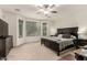 Tranquil main bedroom with a ceiling fan, large windows, and comfortable seating at 17937 W Westpark Blvd, Surprise, AZ 85388