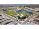 An aerial view showing a community pool, playground, and pond in a new neighborhood at 19195 N Los Gabrieles Way, Maricopa, AZ 85138