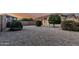 Spacious backyard featuring gravel landscaping for easy maintenance and mature shrubbery at 20858 E Sonoqui Dr, Queen Creek, AZ 85142
