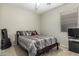 Neutral bedroom with queen bed, window and tv at 20858 E Sonoqui Dr, Queen Creek, AZ 85142
