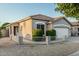 Charming single-story home showcasing desert landscaping, a tiled roof, and a two-car garage at 20858 E Sonoqui Dr, Queen Creek, AZ 85142