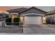 Charming single-story home showcasing a well-manicured front yard and a two-car garage at 20858 E Sonoqui Dr, Queen Creek, AZ 85142