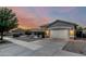 Inviting home featuring low-maintenance desert landscaping and a spacious driveway at 20858 E Sonoqui Dr, Queen Creek, AZ 85142
