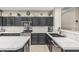 Modern kitchen with gray cabinets, stainless steel appliances, and marble countertops at 20858 E Sonoqui Dr, Queen Creek, AZ 85142
