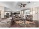Open-concept living room featuring hardwood floors and opening into a kitchen with modern appliances at 20858 E Sonoqui Dr, Queen Creek, AZ 85142