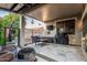 Inviting covered patio with comfortable seating, grill, and serene backyard views at 20858 E Sonoqui Dr, Queen Creek, AZ 85142