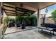 Covered patio with comfortable seating, fire pit, and outdoor kitchen area perfect for entertaining at 20858 E Sonoqui Dr, Queen Creek, AZ 85142