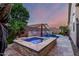 A sparkling backyard pool and spa with stone accents, perfect for outdoor entertaining and relaxation at 20858 E Sonoqui Dr, Queen Creek, AZ 85142