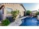 A beautiful backyard pool and spa are complimented by elegant stone work, landscaping and a private outdoor living area at 20858 E Sonoqui Dr, Queen Creek, AZ 85142