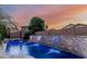 Inviting pool with waterfall feature and mature landscaping, creating a backyard oasis at 20858 E Sonoqui Dr, Queen Creek, AZ 85142