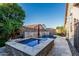 Inviting backyard pool and spa feature stone accents, water features, and lush landscaping for outdoor relaxation at 20858 E Sonoqui Dr, Queen Creek, AZ 85142