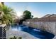 Sparkling pool features a stone waterfall and spa, perfect for cooling off and relaxation in a private backyard setting at 20858 E Sonoqui Dr, Queen Creek, AZ 85142