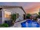 Backyard pool with a spa, lush landscaping, and covered patio, perfect for outdoor living at 20858 E Sonoqui Dr, Queen Creek, AZ 85142