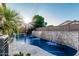 Sparkling pool features a stone waterfall and spa, perfect for cooling off and relaxation in a private backyard setting at 20858 E Sonoqui Dr, Queen Creek, AZ 85142