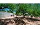 Spacious backyard provides shade, desert landscaping, a rock wall and wood storage at 2101 S 167Th Dr, Goodyear, AZ 85338