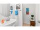 Powder room featuring pedestal sink with decorative artwork and accessories at 2101 S 167Th Dr, Goodyear, AZ 85338