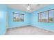 Bright bedroom with blue walls, plush carpet, and view-enhancing window blinds at 2101 S 167Th Dr, Goodyear, AZ 85338