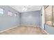 Empty bedroom with neutral walls, two windows, and carpeted floors at 2101 S 167Th Dr, Goodyear, AZ 85338