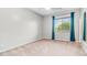 Neutral bedroom featuring plush carpet, light gray walls, and bright window at 2101 S 167Th Dr, Goodyear, AZ 85338