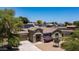 Charming home with solar panels, manicured landscape, and secure entry gate at 2101 S 167Th Dr, Goodyear, AZ 85338