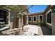 Front entrance with a charming tree, decorative art, desert landscaping, and stone walkway to front door at 2101 S 167Th Dr, Goodyear, AZ 85338