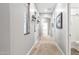 Neutral hallway featuring carpet, and decorative lighting fixtures at 2101 S 167Th Dr, Goodyear, AZ 85338