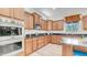 Well-lit kitchen with stainless steel appliances, granite countertops, and light wood cabinetry at 2101 S 167Th Dr, Goodyear, AZ 85338