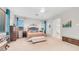 Bright main bedroom with a sitting bench, and an archway to the bathroom at 2101 S 167Th Dr, Goodyear, AZ 85338