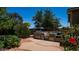 An outdoor kitchen features a stainless steel grill and verdant landscaping, perfect for entertaining at 2101 S 167Th Dr, Goodyear, AZ 85338