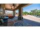 Comfortable covered patio featuring a cozy outdoor lounge area and decorative rug overlooking the pool and yard at 2101 S 167Th Dr, Goodyear, AZ 85338