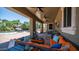 Inviting covered outdoor living space with cozy seating, ceiling fans, and view of pool at 2101 S 167Th Dr, Goodyear, AZ 85338