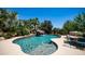 Stunning pool with rock waterfall, lush landscaping, and an inviting outdoor dining area at 2101 S 167Th Dr, Goodyear, AZ 85338